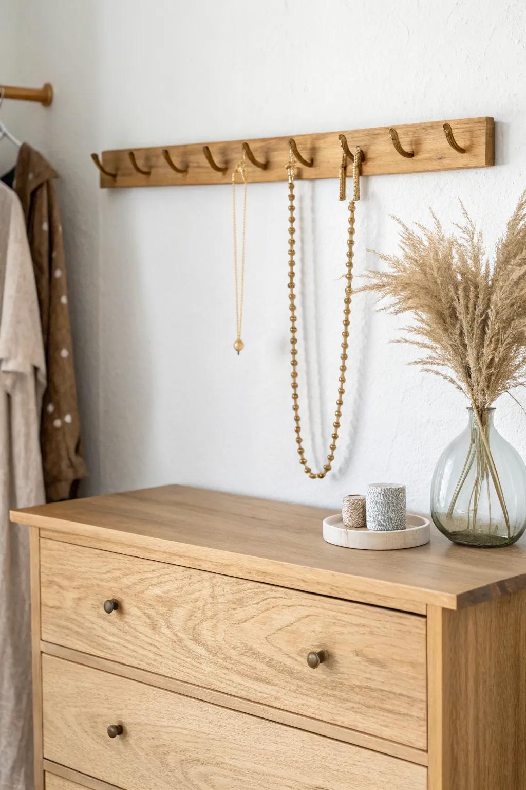 DIY wall hook rail: a minimal wood-and-brass solution to keep necklaces tangle-free.
