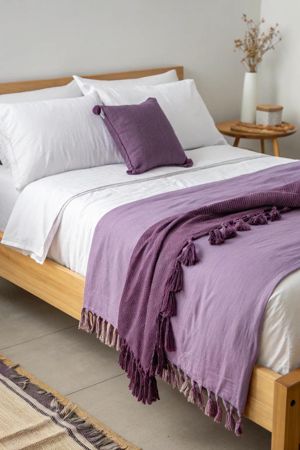 Layer lilac and plum bedding to make a tiny dorm bed look instantly designed.