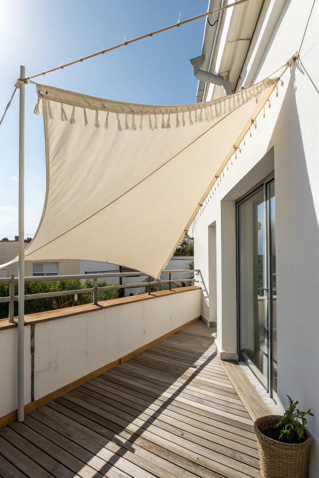 Simple linen canopy shade—angled for rain runoff—makes a small balcony deck summer-ready.