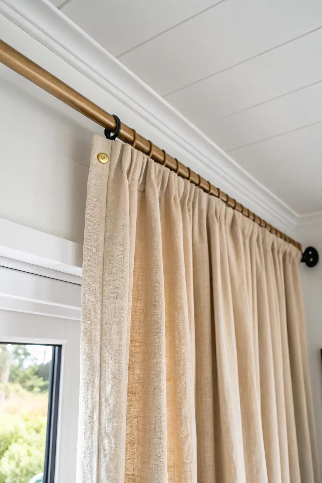 Ceiling-mounted linen curtain track—an easy closet “door” that makes small rooms feel taller.