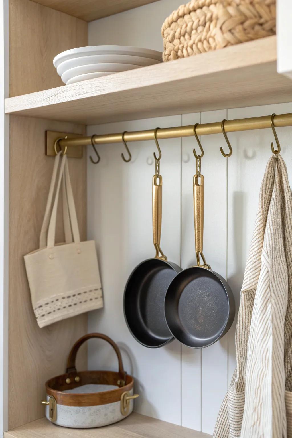 A slim brass hanging rail inside the cabinet keeps pans off shelves—simple, luxe, space-saving.