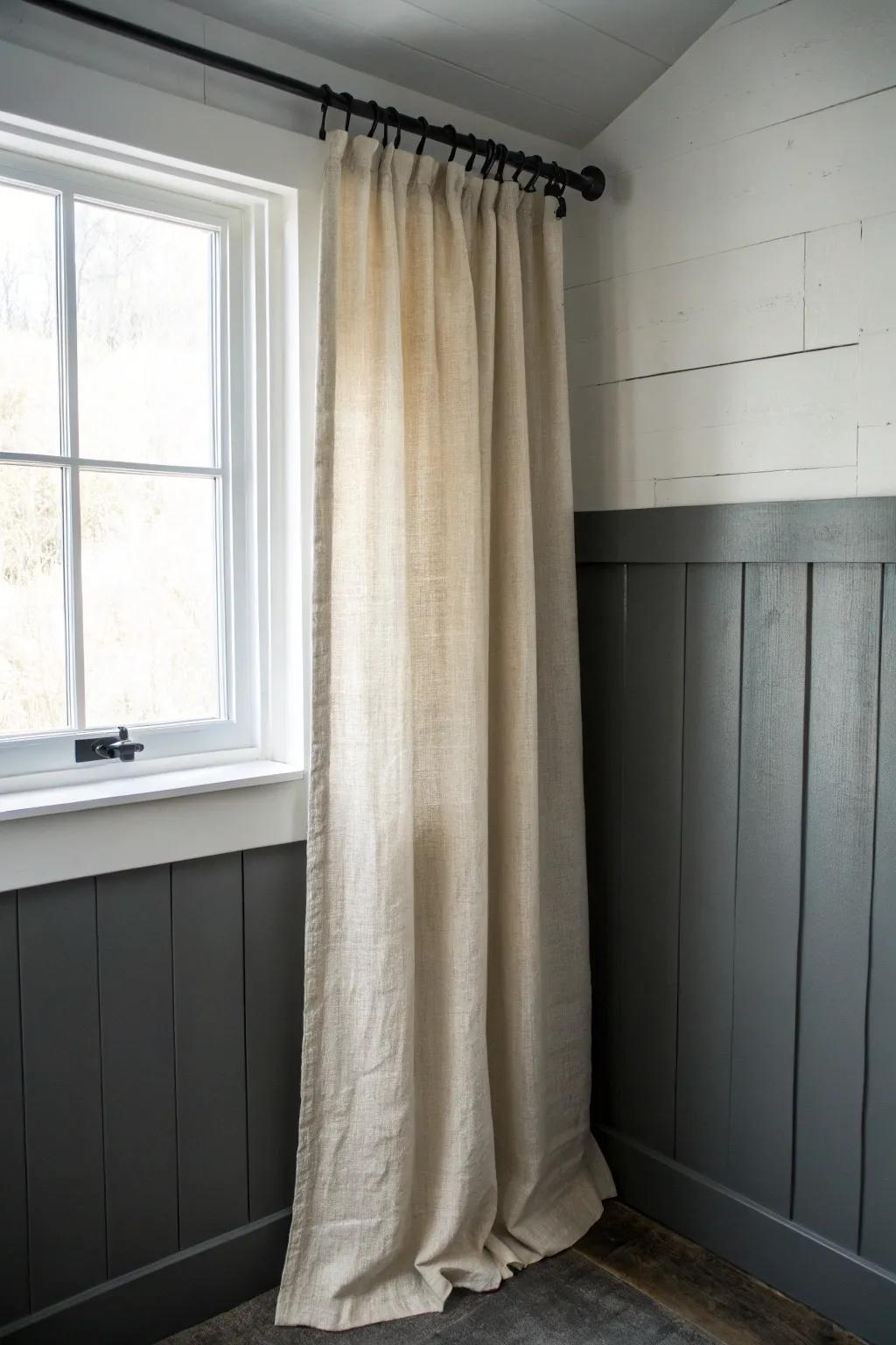 Budget basement upgrade: a linen curtain hides utility clutter and makes the space look polished.