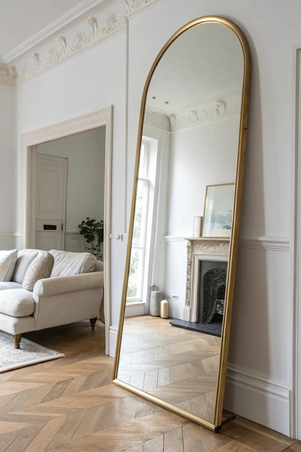 A bold arched mirror doubles the light and adds instant classic elegance in a small living room.