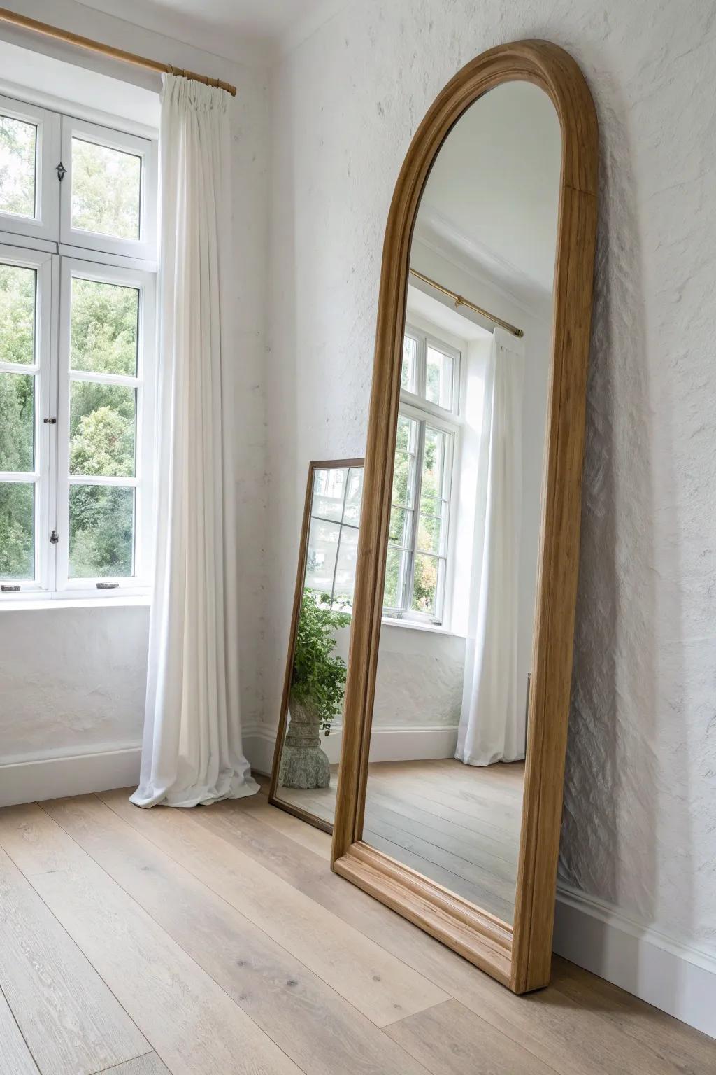Hang an oversized mirror opposite a window to bounce light and make a narrow room feel wider.