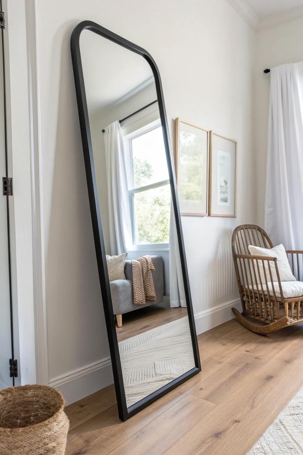 A large arched mirror bounces light around, making a tiny baby boy nursery feel bigger.