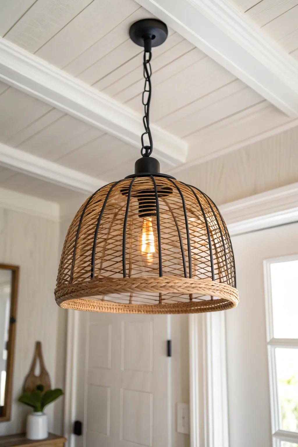 A bold ceiling pendant turns a tiny entry into a warm, styled welcome—add a dimmer for mood.