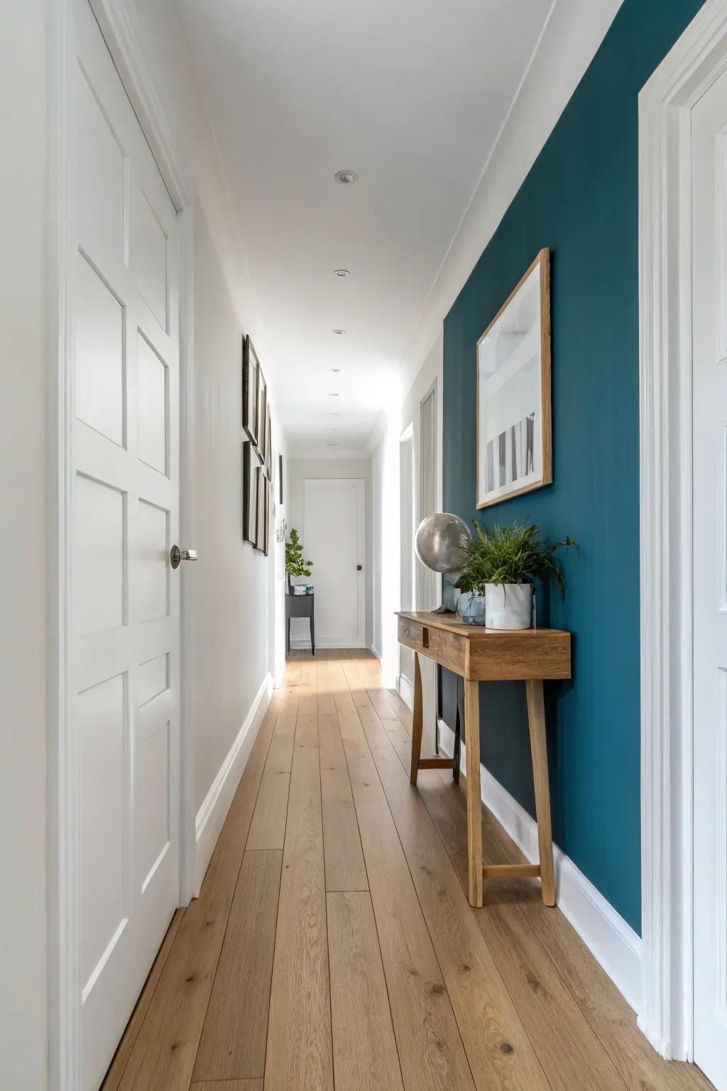 Paint the end wall deep and let one simple handcrafted piece anchor the hallway’s destination.