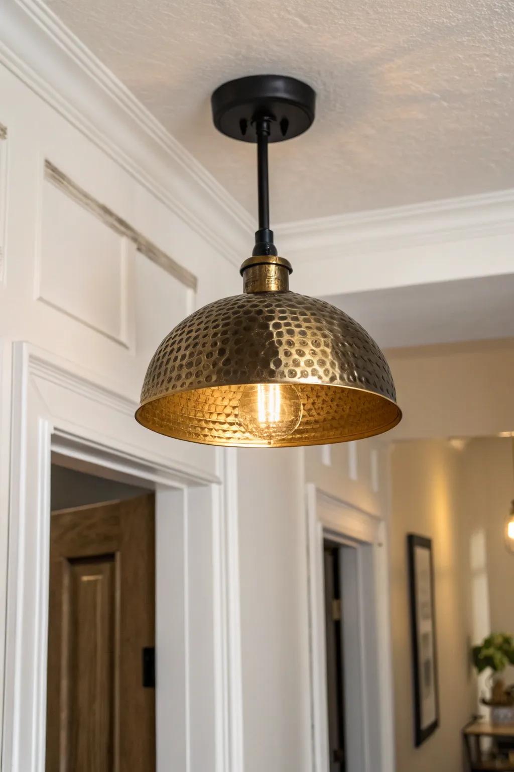 Brass + matte black hallway light: a mixed-metal statement that makes small spaces feel curated.