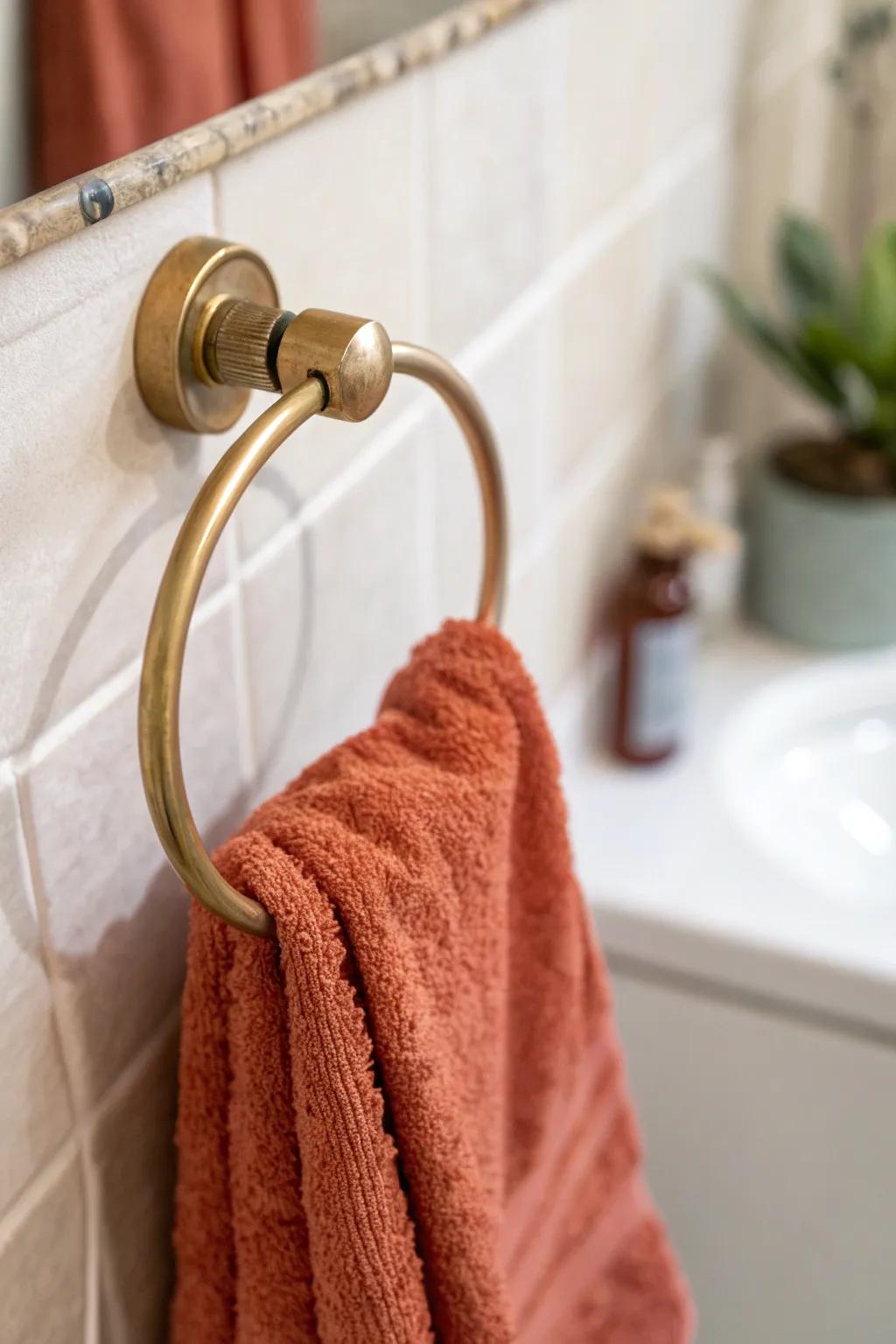 Trade the towel bar for a chic ring—more clearance, better flow in a tiny office bathroom.