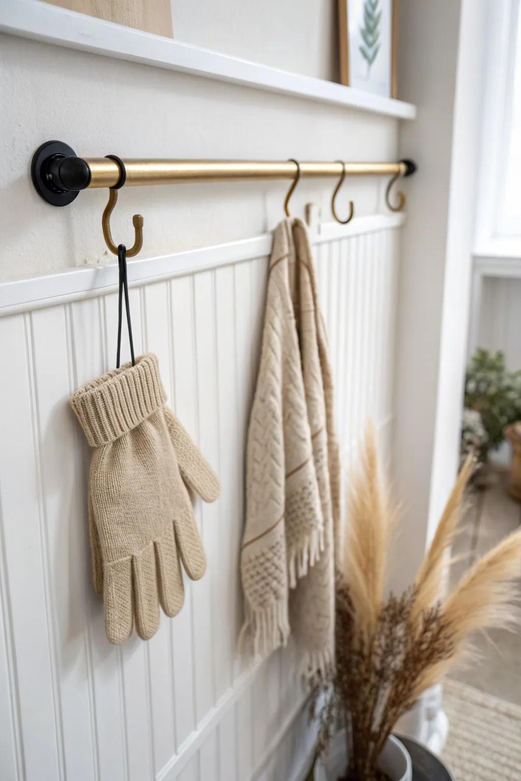 Binder clips + a slim rod turn gloves into tidy “flags” for a chic, space-saving entryway.