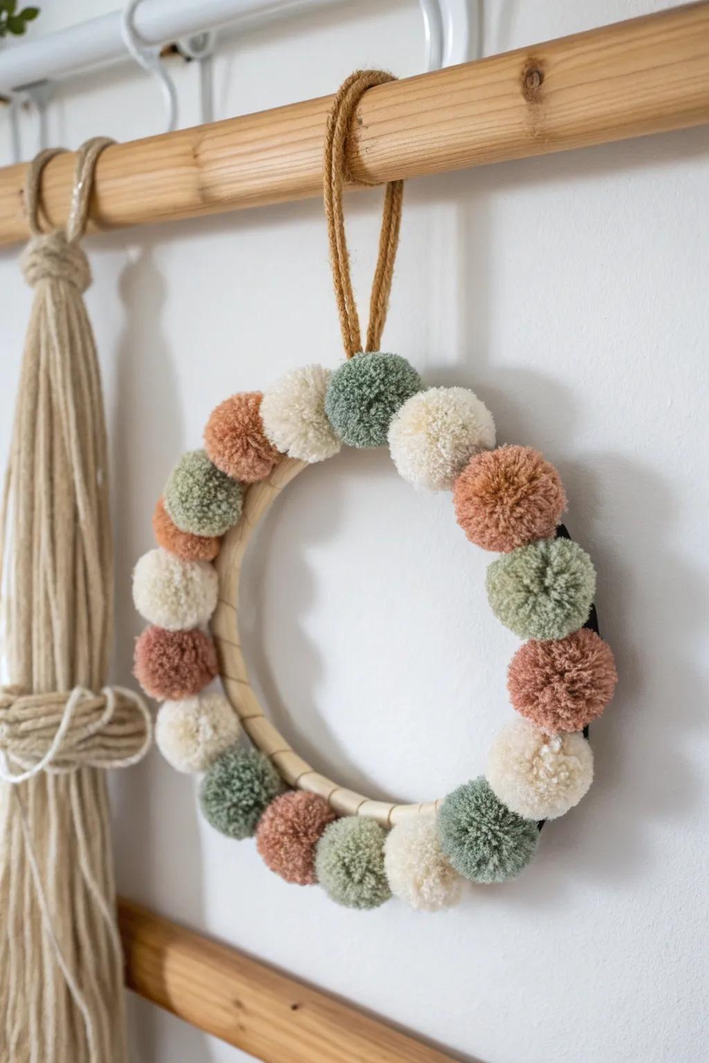 Playful pom‑pom mini wreath: a tiny, cozy pop of color for hooks, rails, and small halls.