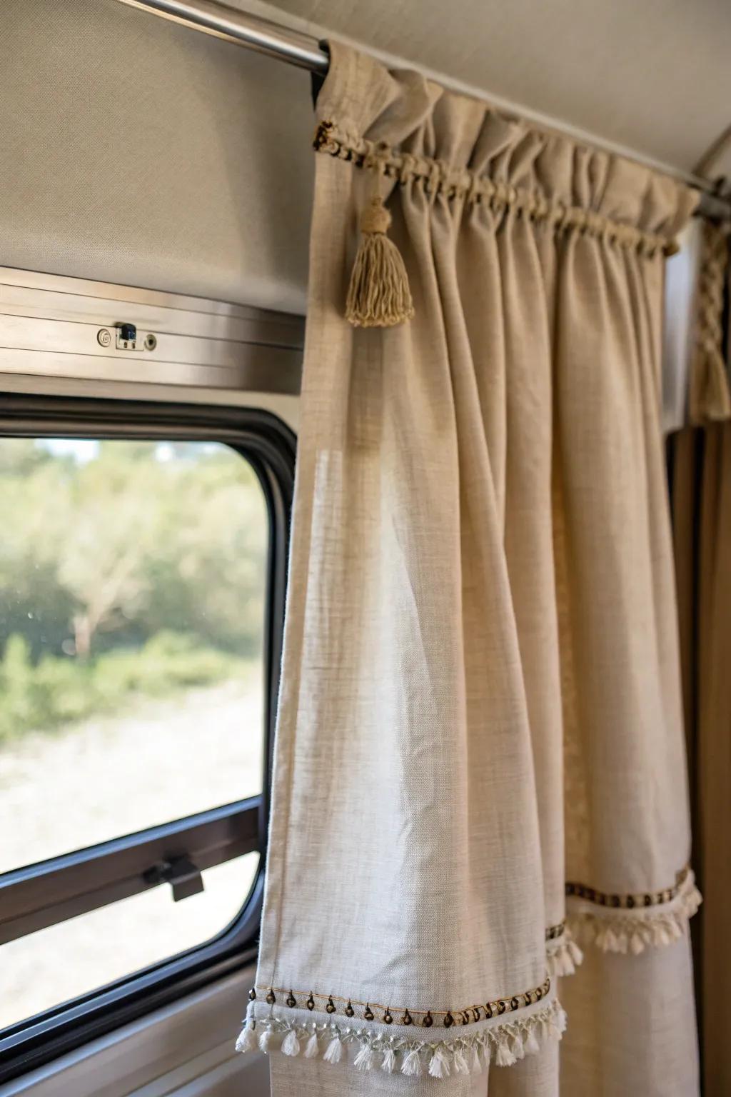 Tone-on-tone linen curtains that blend into the wall make tiny RV windows feel wider.