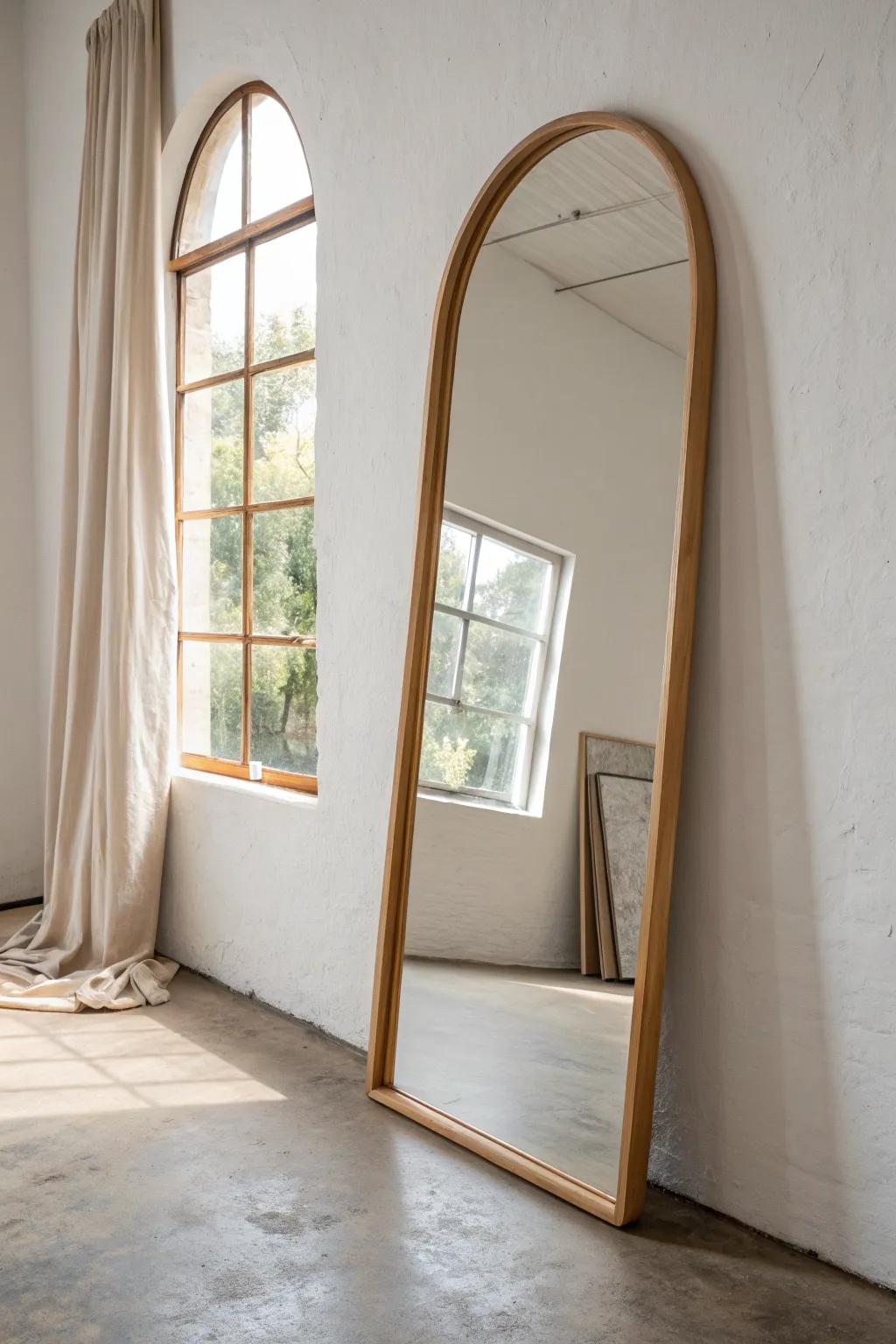 A large arched mirror opposite the window bounces light and instantly brightens a small basement.