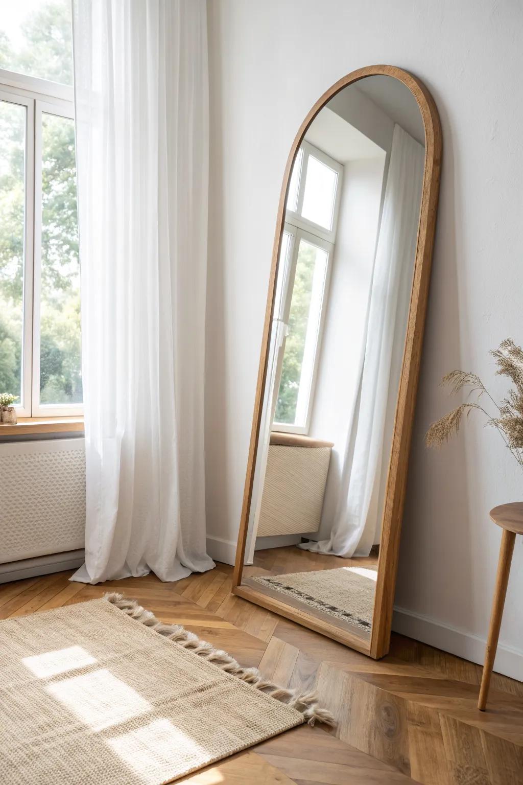One oversized mirror opposite the window doubles light and makes a studio feel bigger.