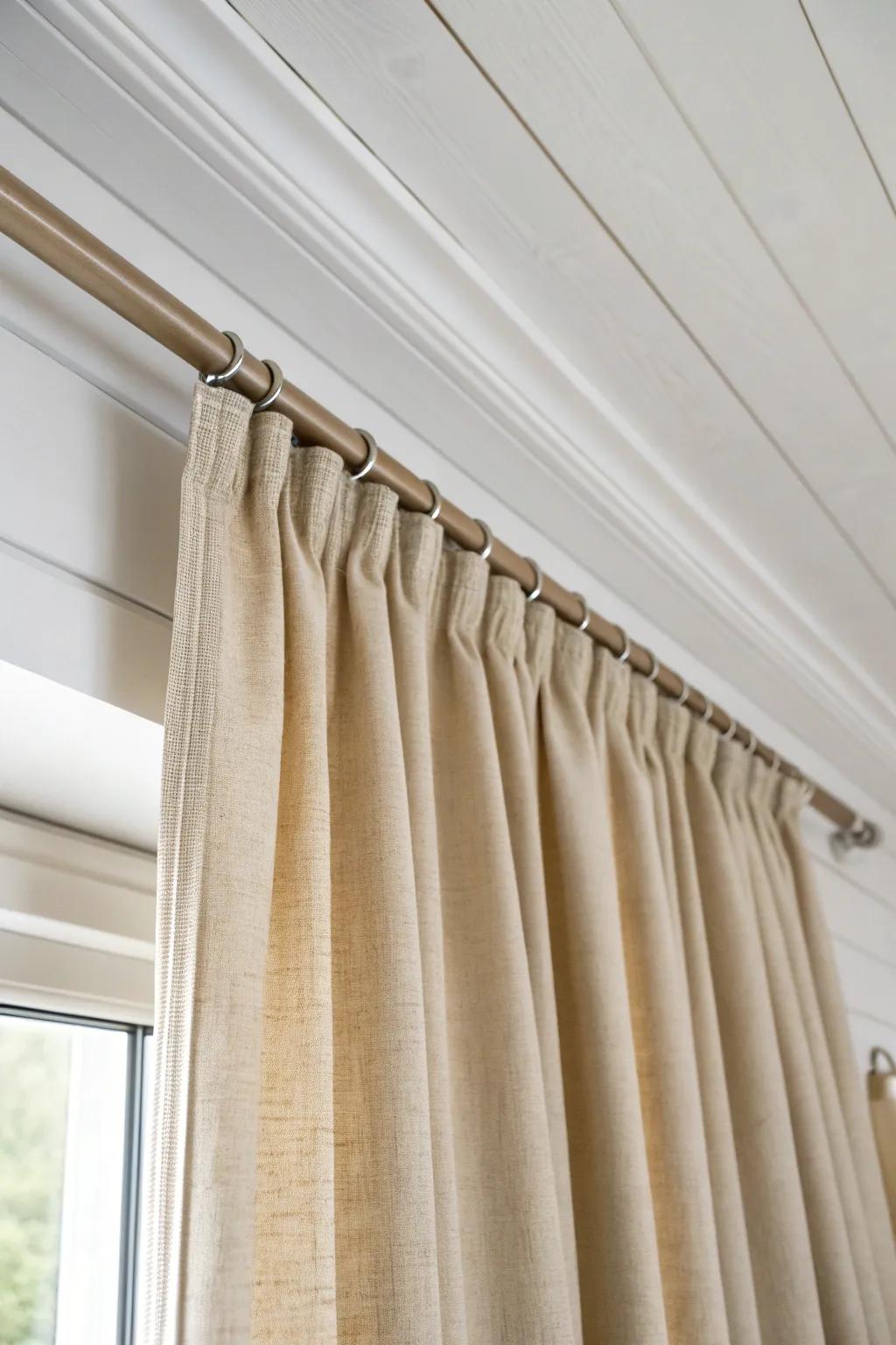 Ceiling-track linen curtains add instant privacy—soft zoning for a modern flex room.