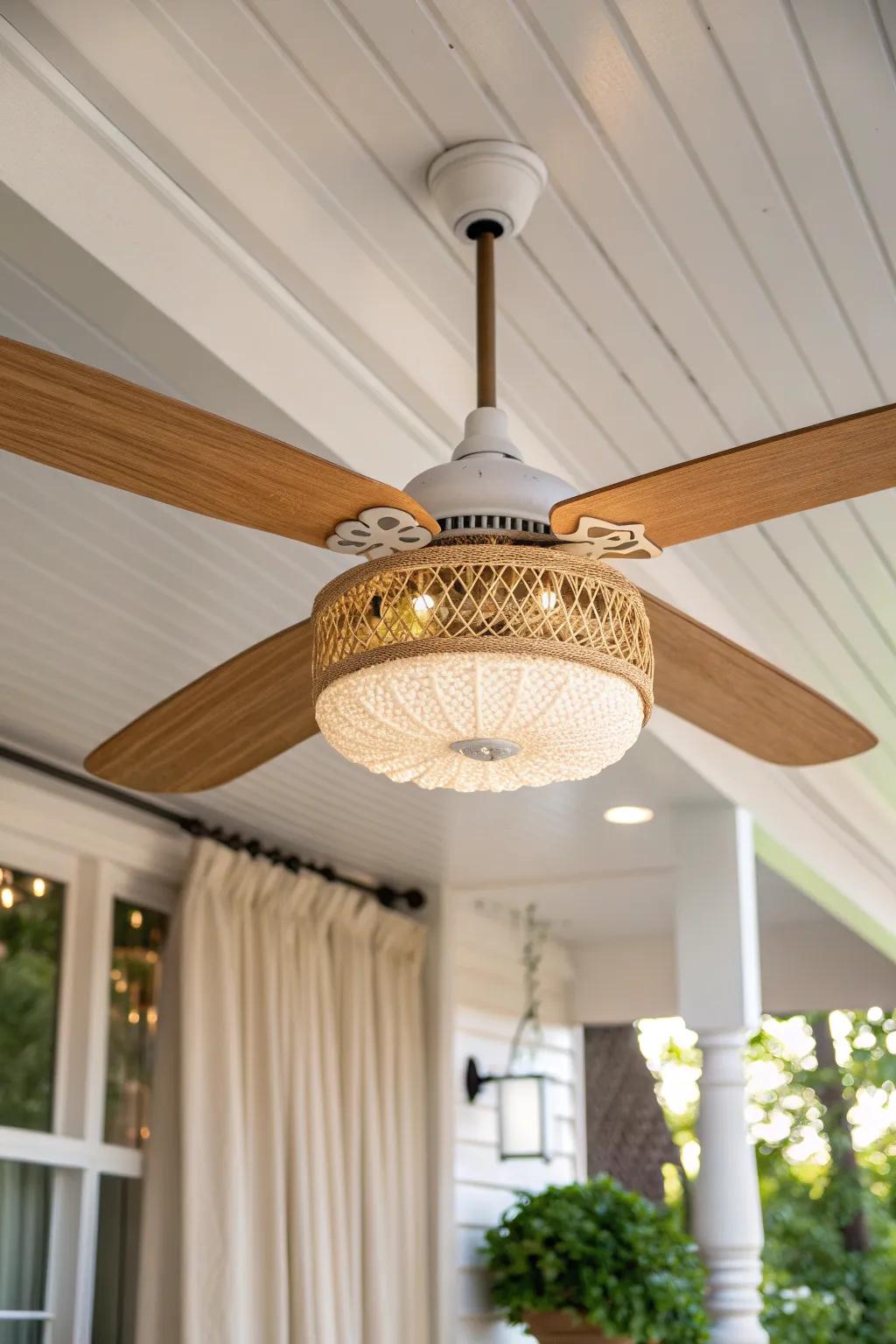 A ceiling fan light adds breezy comfort and warm overhead glow to a small covered porch.
