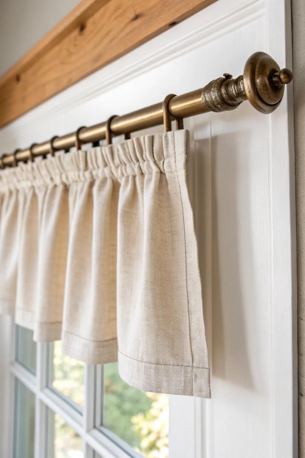 A tiny linen valance on a tension rod instantly hides an uneven frame—bright, airy, and chic.