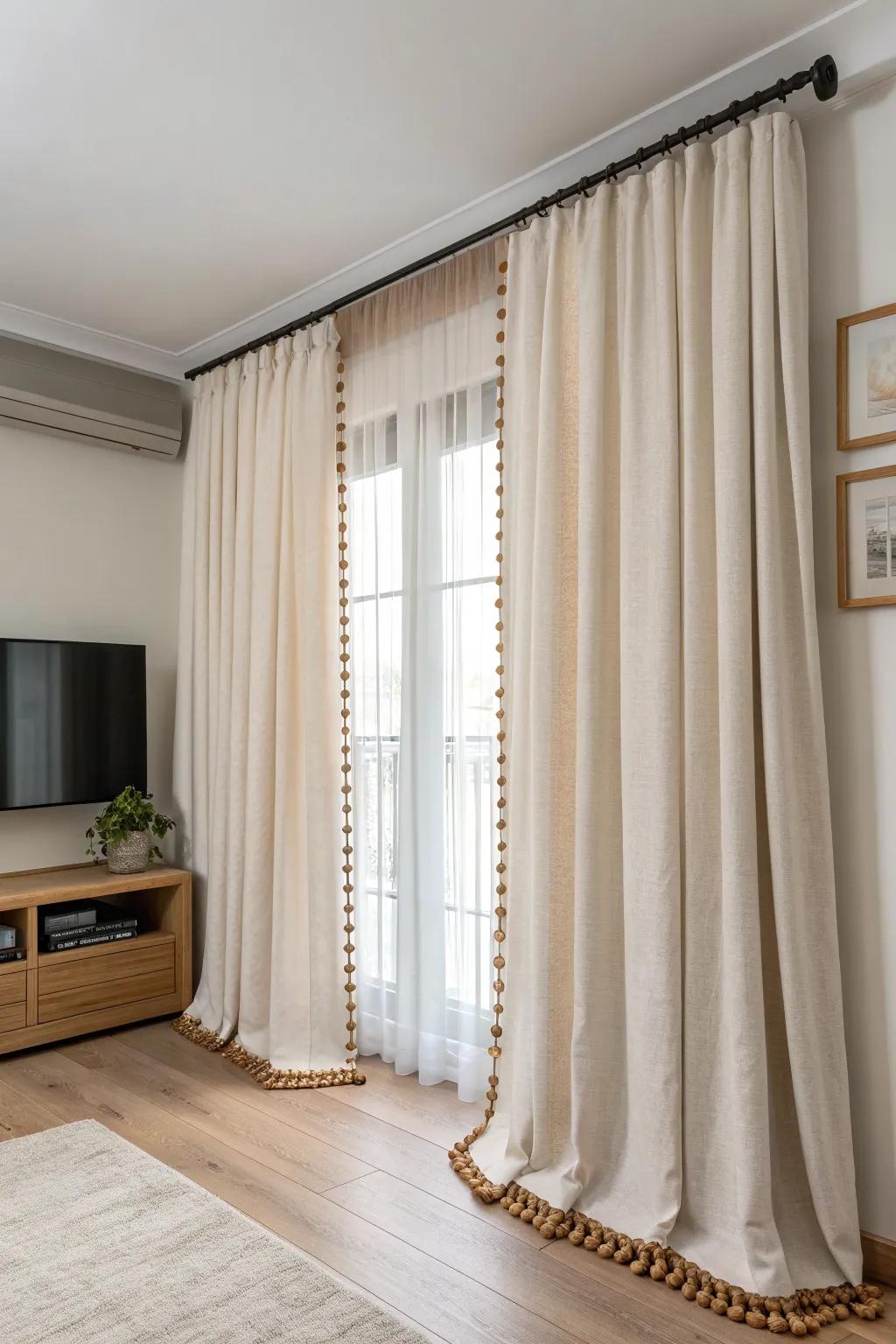 Ceiling-to-floor linen curtains hide the TV for a calmer, tech-free bedroom look.