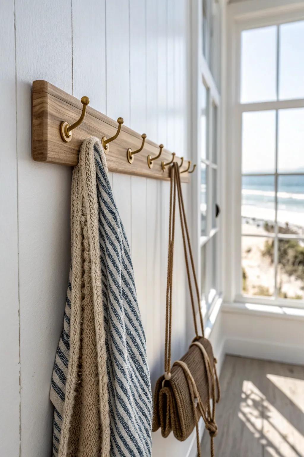 Slim vertical hook rail keeps towels and beach bags off the floor in a tiny condo entry.