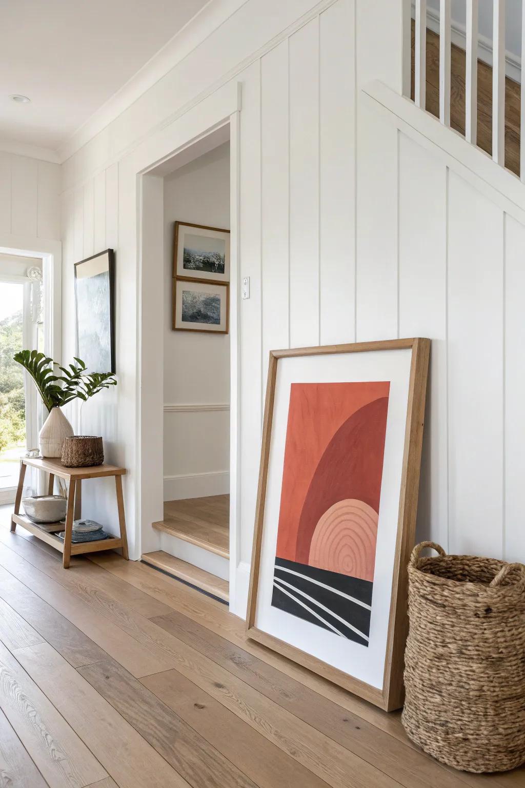 Lean one oversized framed print under a slim shelf for instant, layered entryway style.