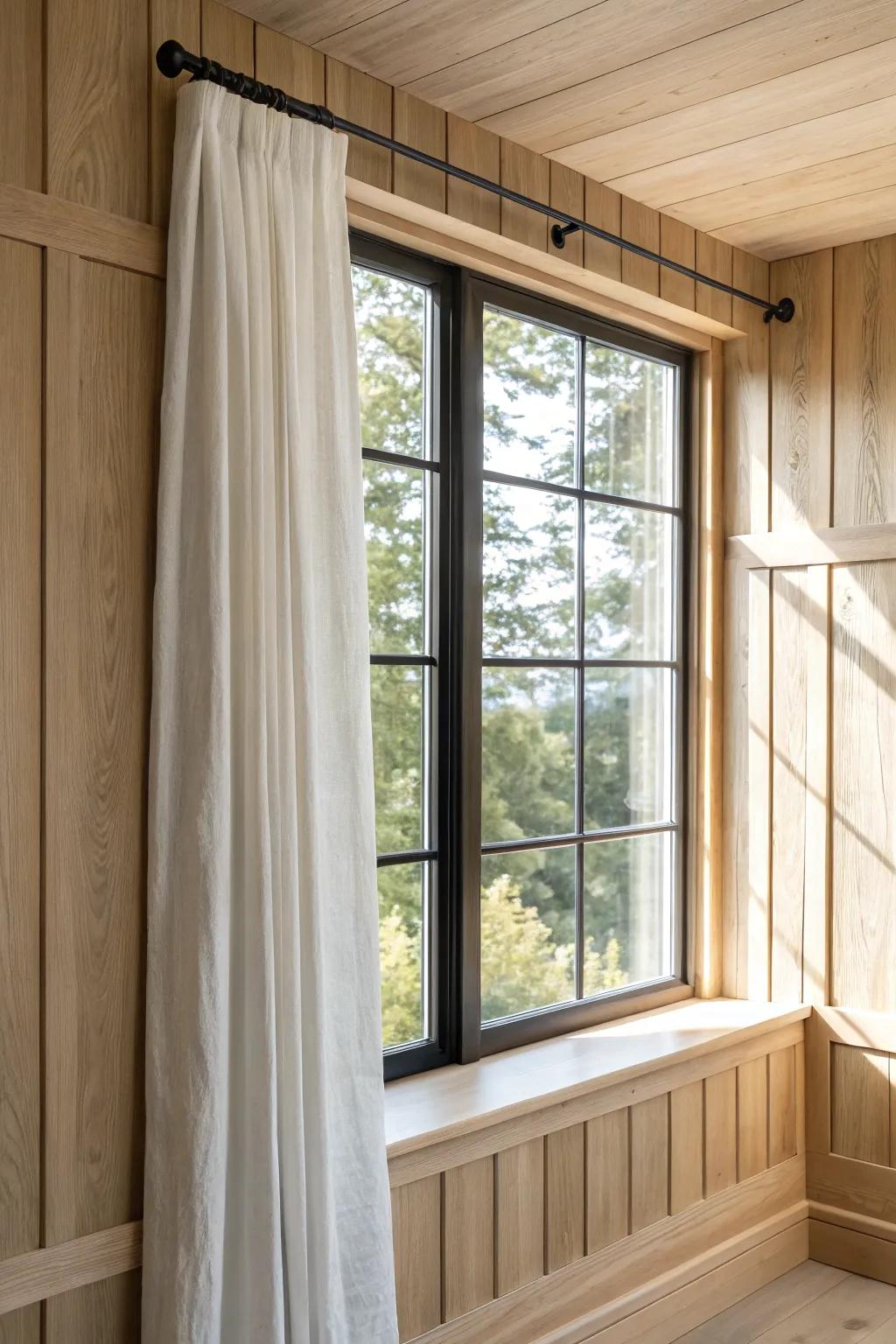 Pale oak paneling wrapped around the window creates a built-in look that elevates simple curtains.