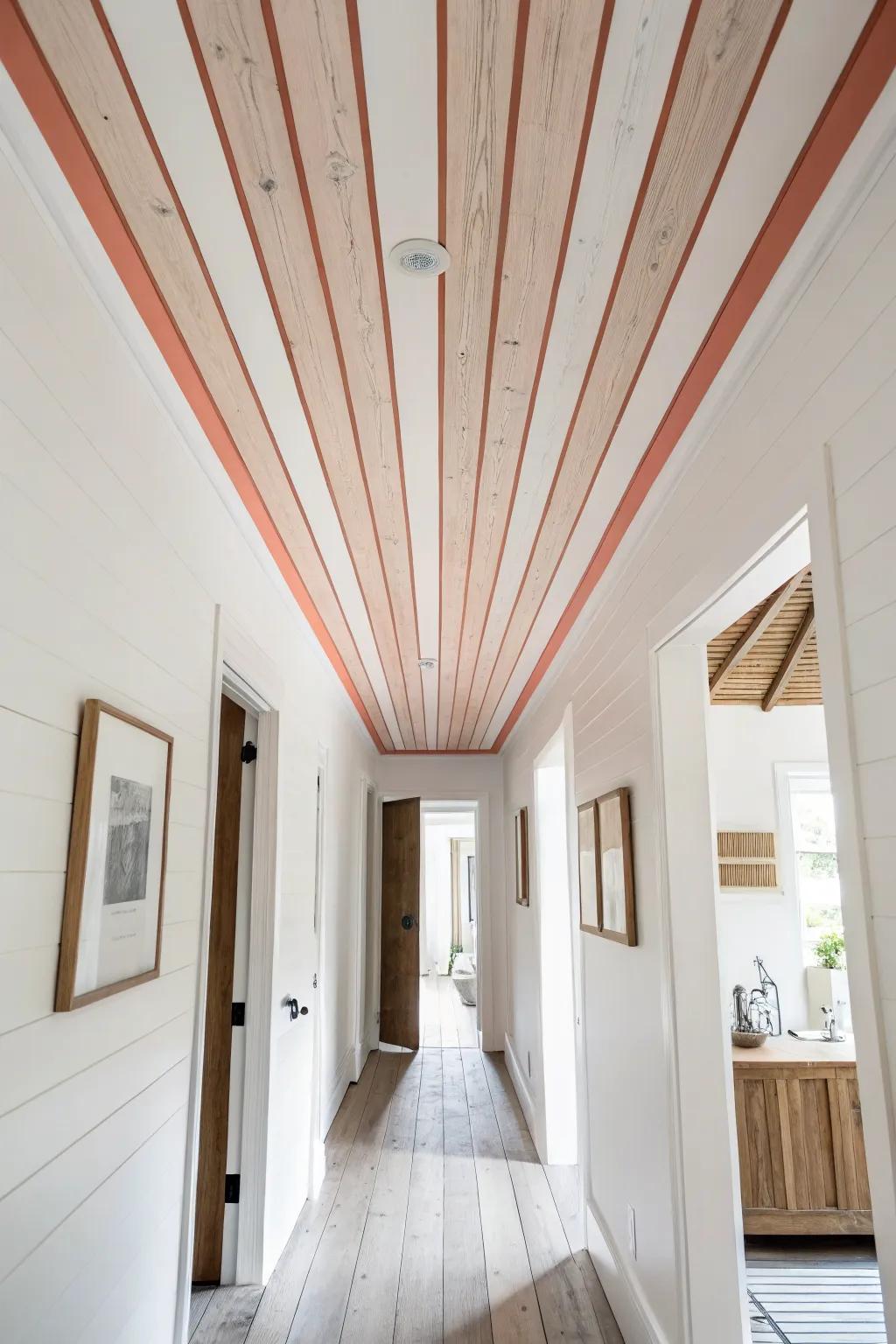 Painted ceiling stripes and warm planks turn a narrow bedroom hallway into a feature.