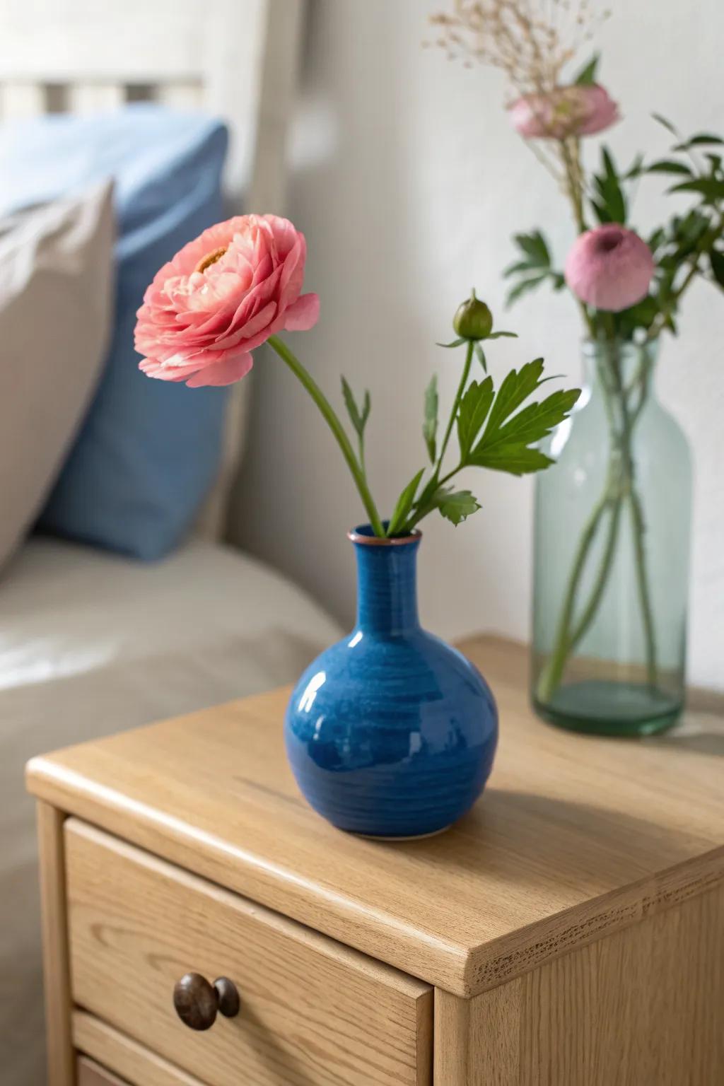 Swap a single stem in a bold handmade vase to refresh your dresser without extra storage.