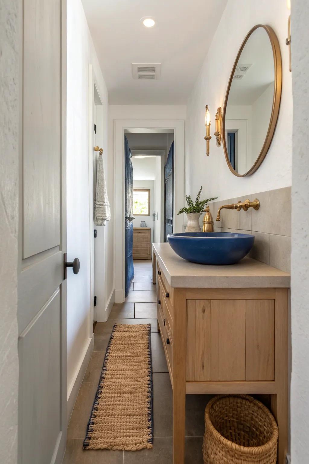 A walk-through galley bathroom with a bold cobalt vessel sink and airy, streamlined flow.