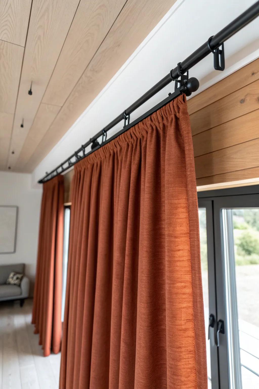 A ceiling-mounted linen curtain divider that instantly hides clutter and calms a small condo.