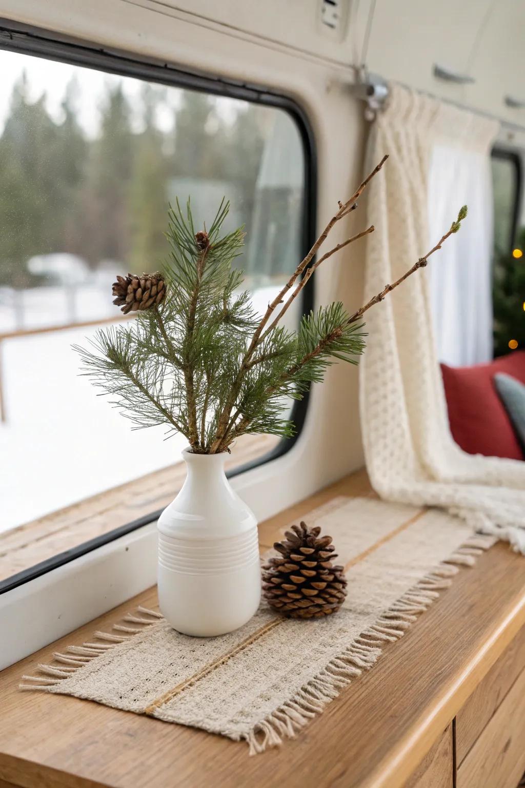 Foraged evergreen + pinecone in a tiny vase—RV-friendly Christmas decor with big cozy vibes.
