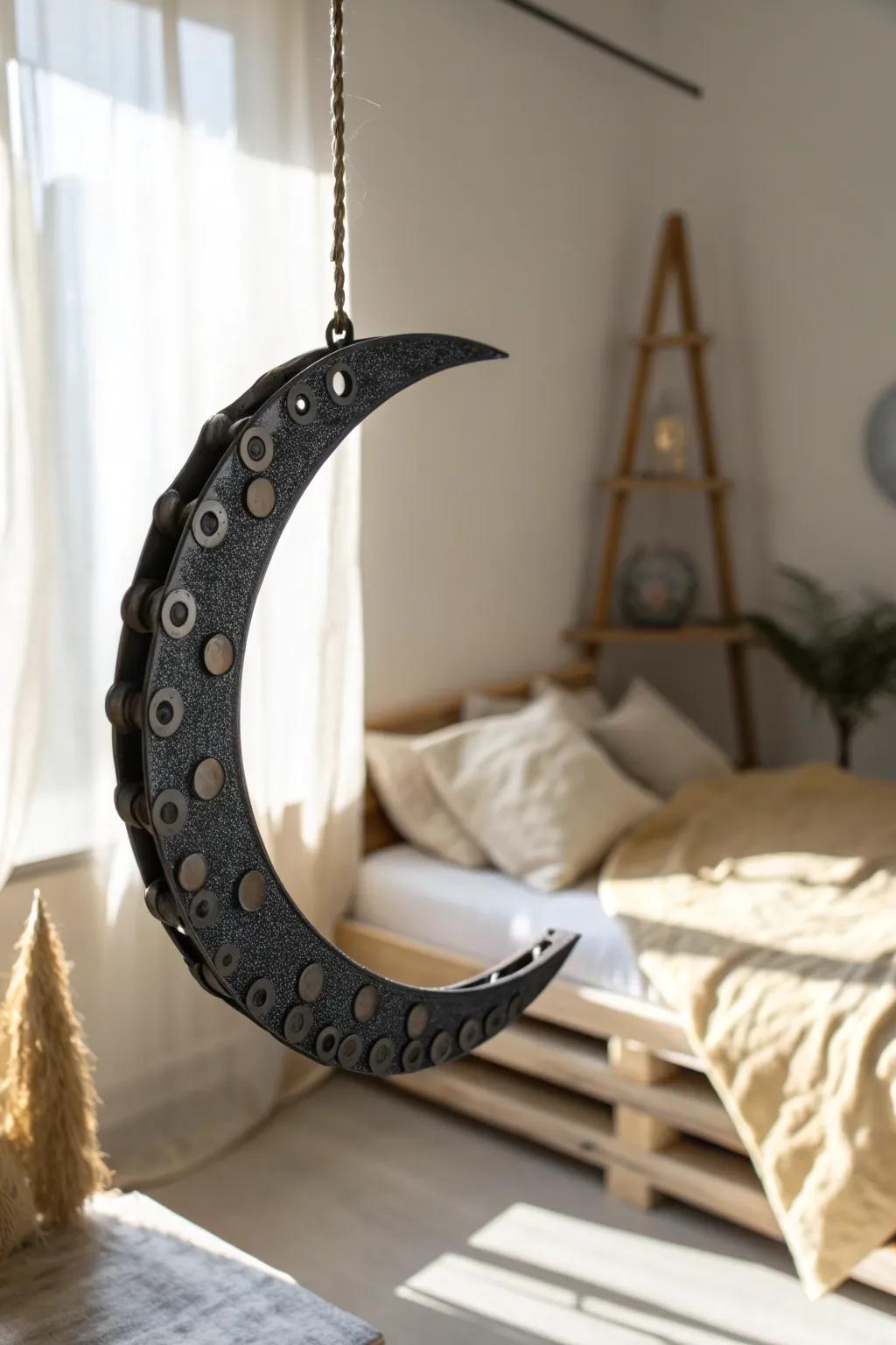 Upcycled bike-chain crescent moon—moody, minimalist metal art that warms up tiny spaces.