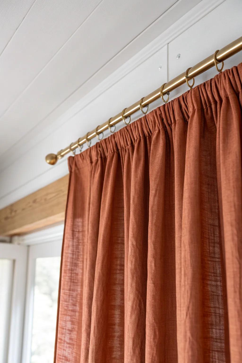 A ceiling-mounted linen curtain neatly conceals your desk zone, keeping the bed feeling calm.