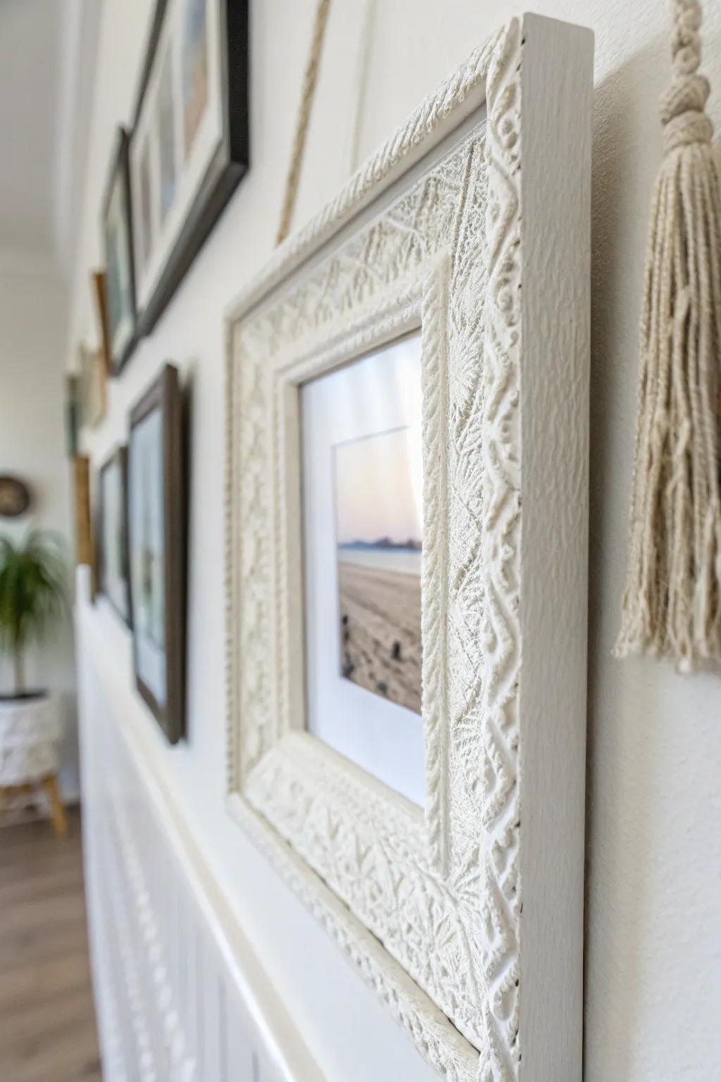 White-on-white frames with textured paper add quiet depth to a small, bright living room.