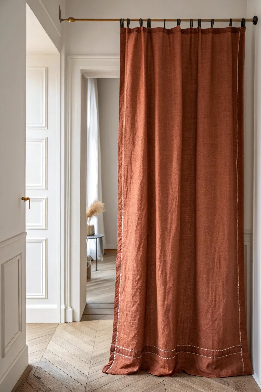 Tension-rod linen curtain turns a tiny hallway recess into chic, renter-friendly hidden storage.