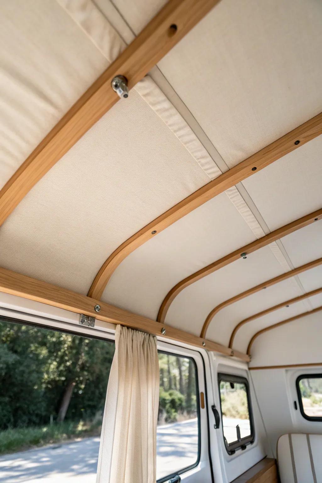 A tight, airy linen ceiling panel makes a tiny camper feel warm, quiet, and custom.