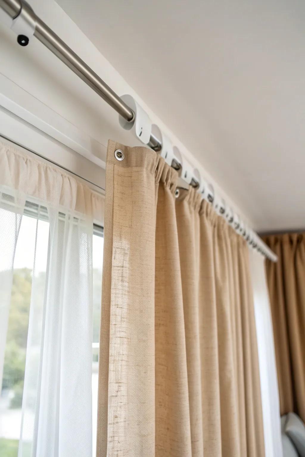Ceiling curtain track + airy linen = a private guest nook that hides the office in seconds.