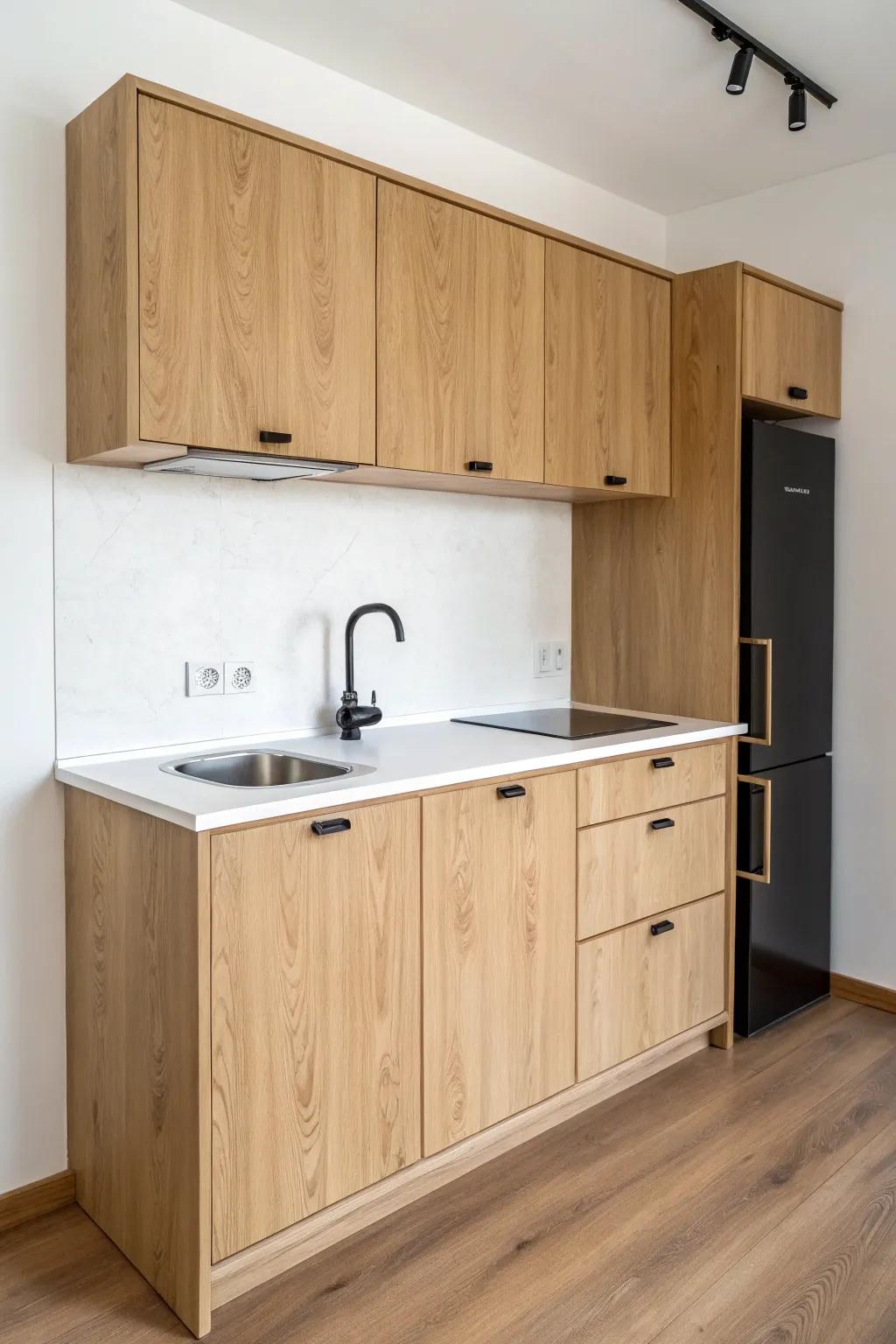 One-wall ADU kitchenette: light oak + matte black details for a small-space layout with big impact.
