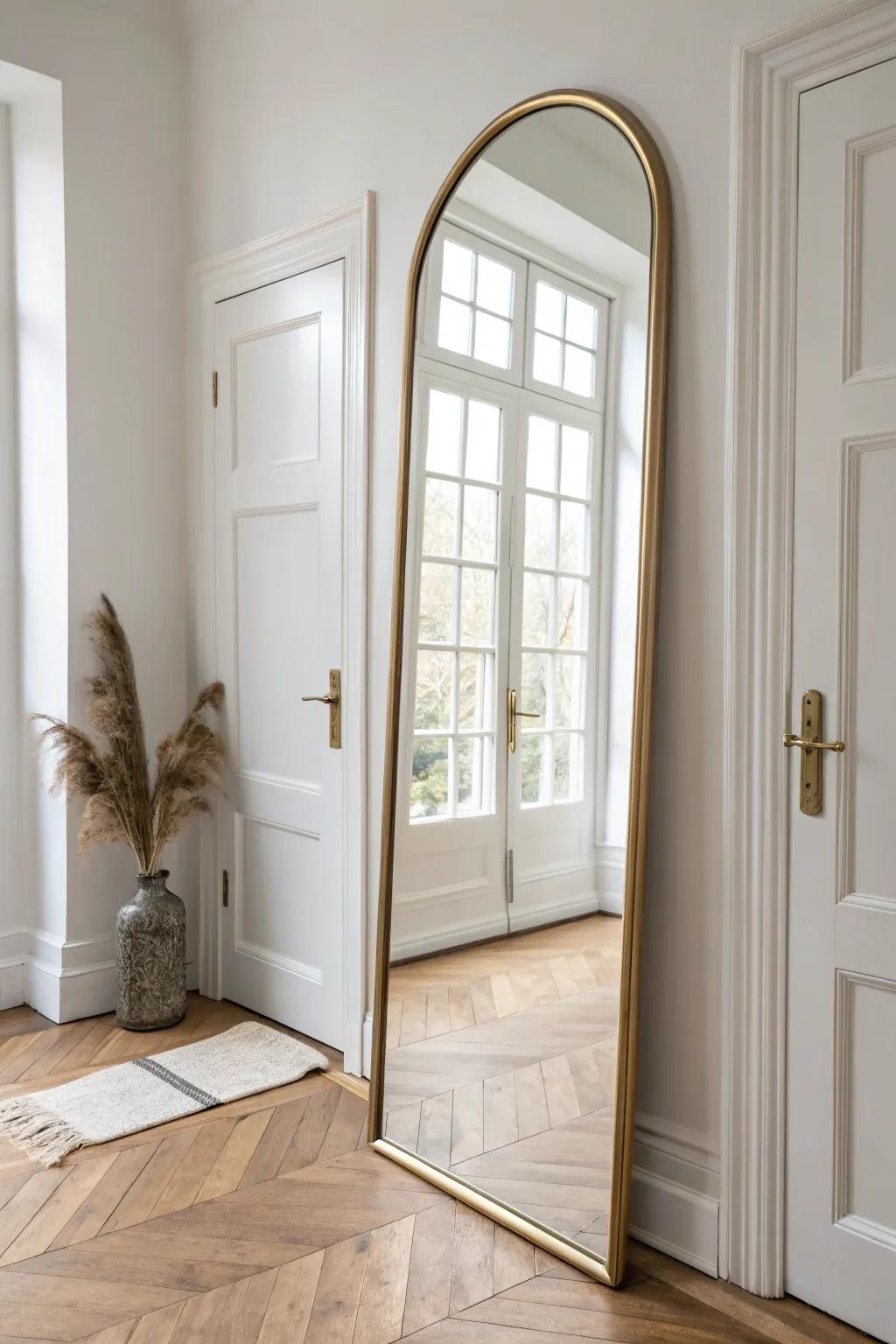 Hang an oversized mirror across from the door to bounce light and widen a small entry.
