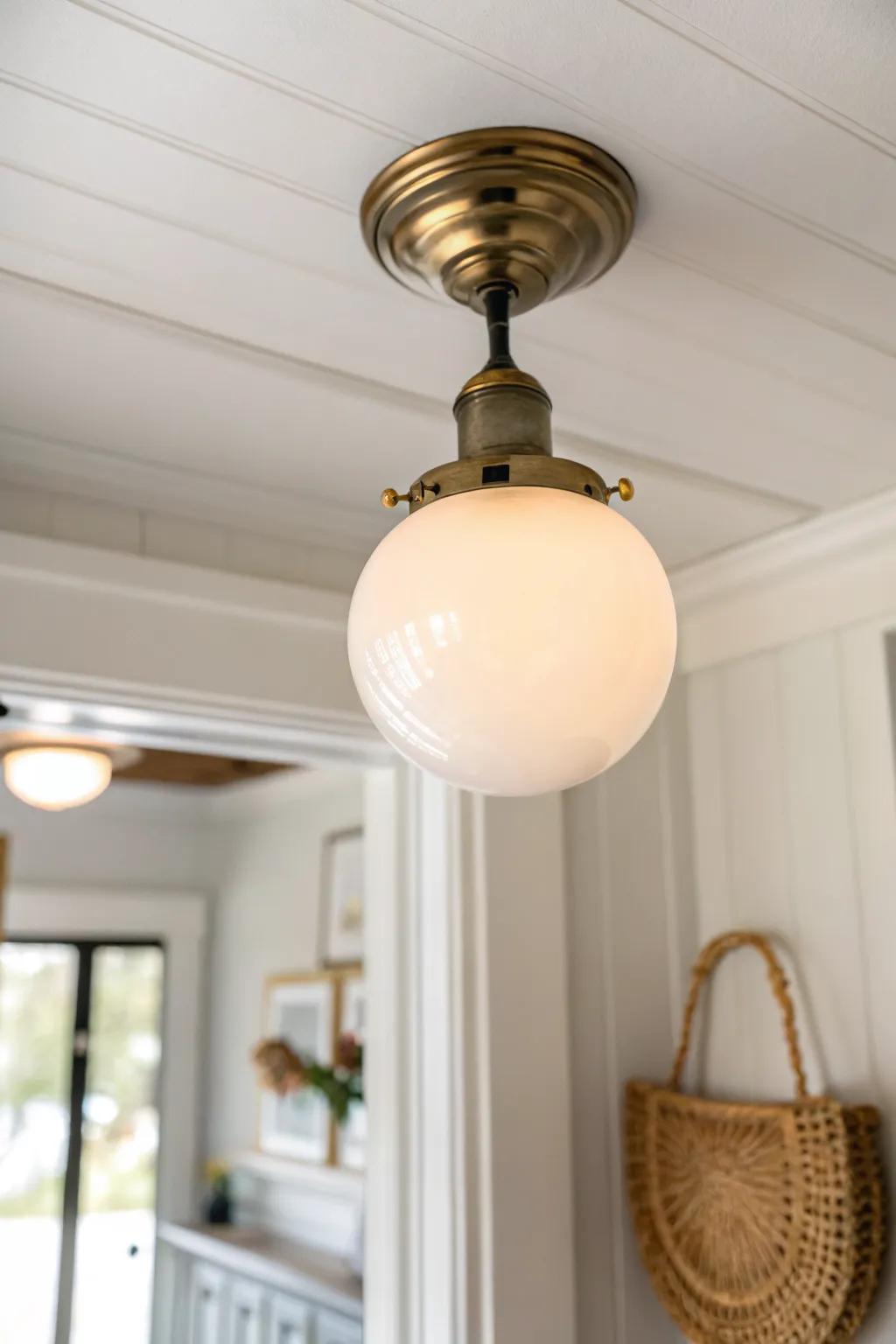 A schoolhouse globe flush mount casts soft, cozy light—perfect for a calm, small entry.