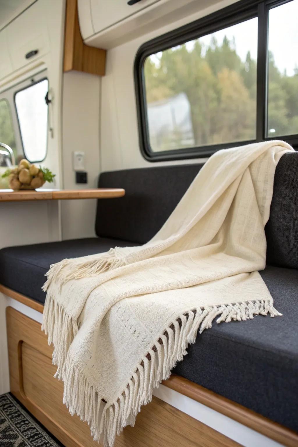 A single soft, washable throw instantly makes a tiny camper feel fresh, warm, and inviting.