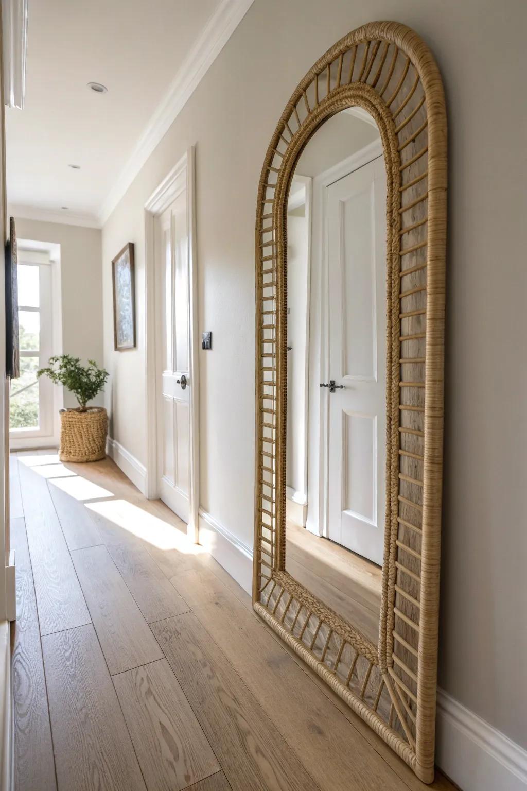 Light, calm walls + a handcrafted rattan mirror instantly lifts a narrow hallway.