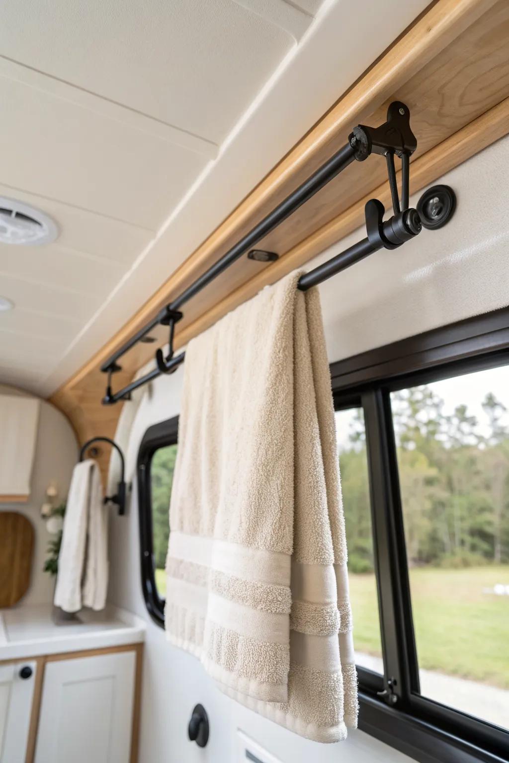 Ceiling slide-rail towel rack: hidden vertical space that keeps RV baths airy and clutter-free.