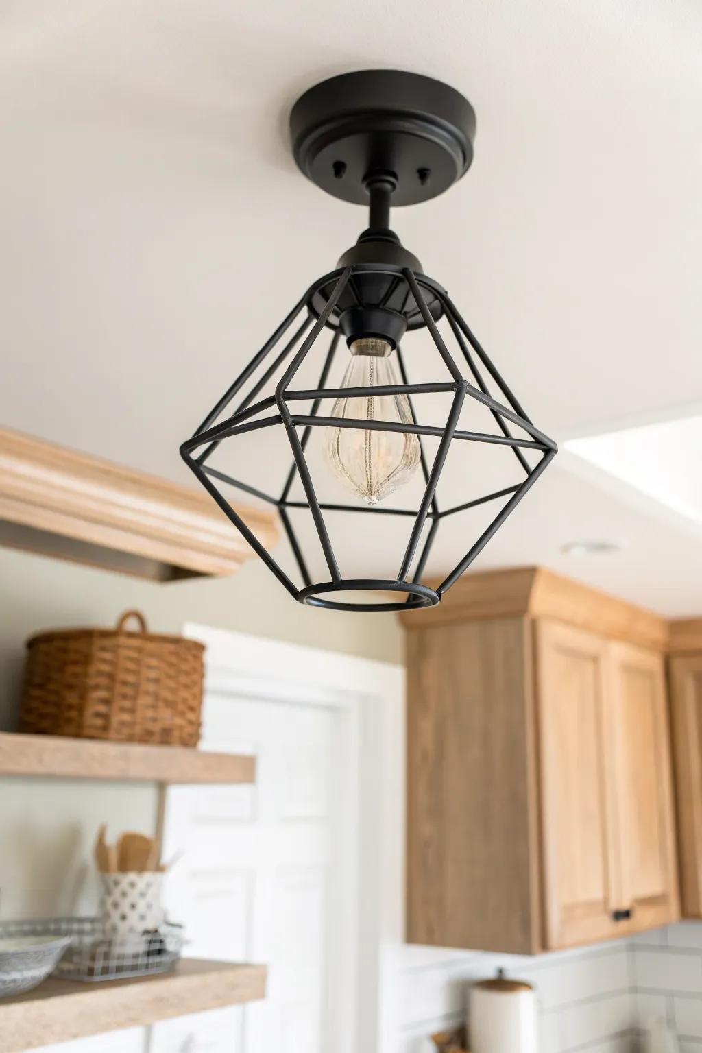 Matte black caged flush mount adds bold contrast and clean overhead lighting in a small kitchen.
