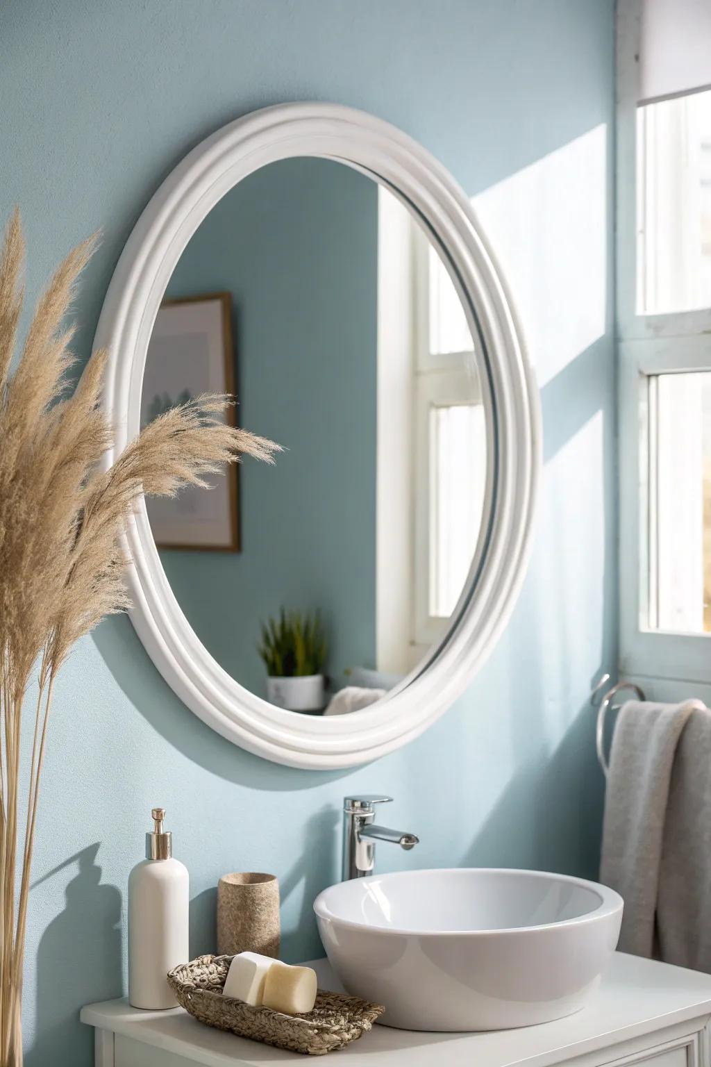 Pale blue walls + crisp white accents make a tiny bathroom feel like a calm, airy spa.