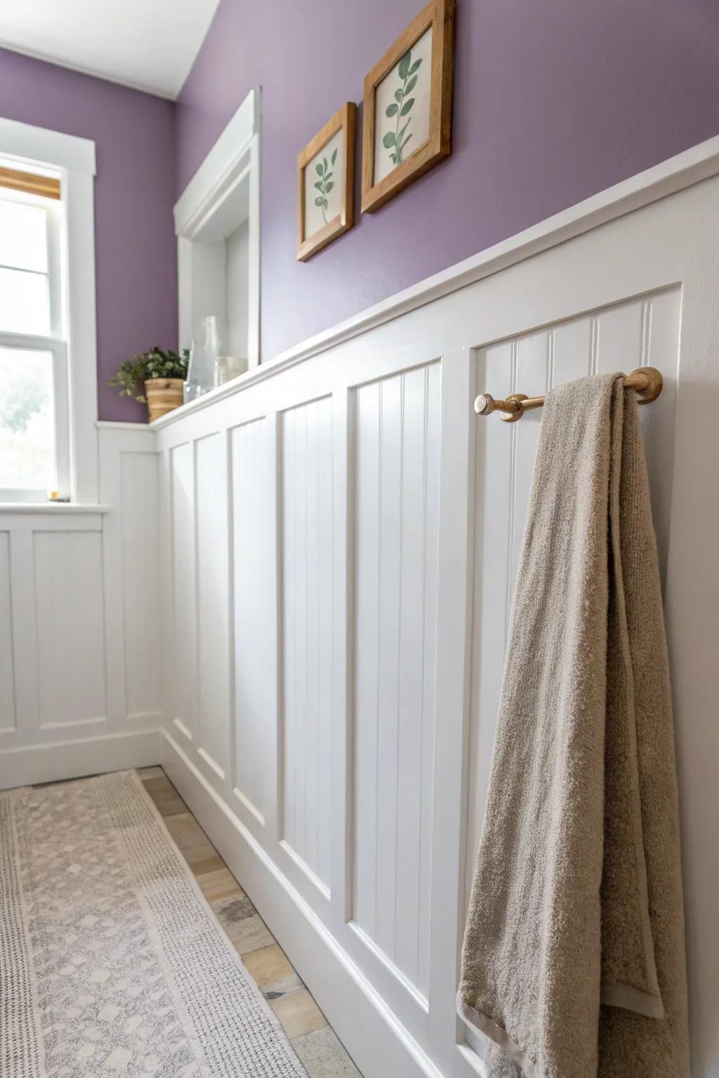 White wainscoting + dusty purple above makes a small bathroom feel taller and polished.