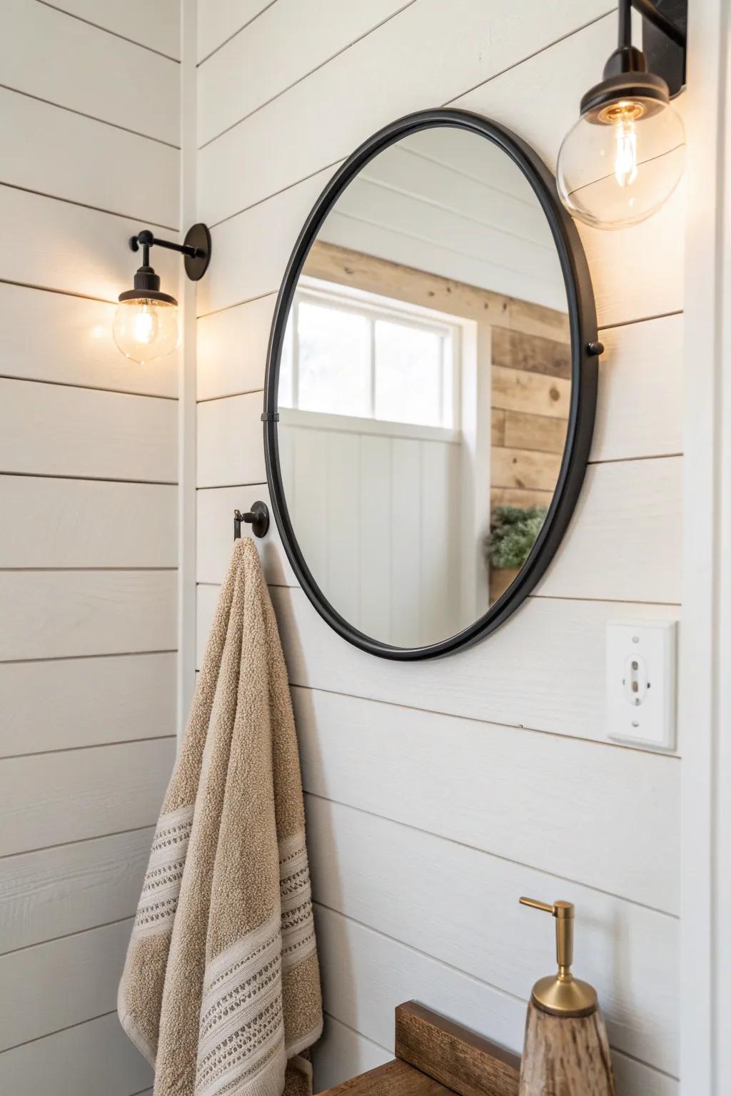 Creamy shiplap behind a round mirror adds western warmth while keeping a small bath airy.