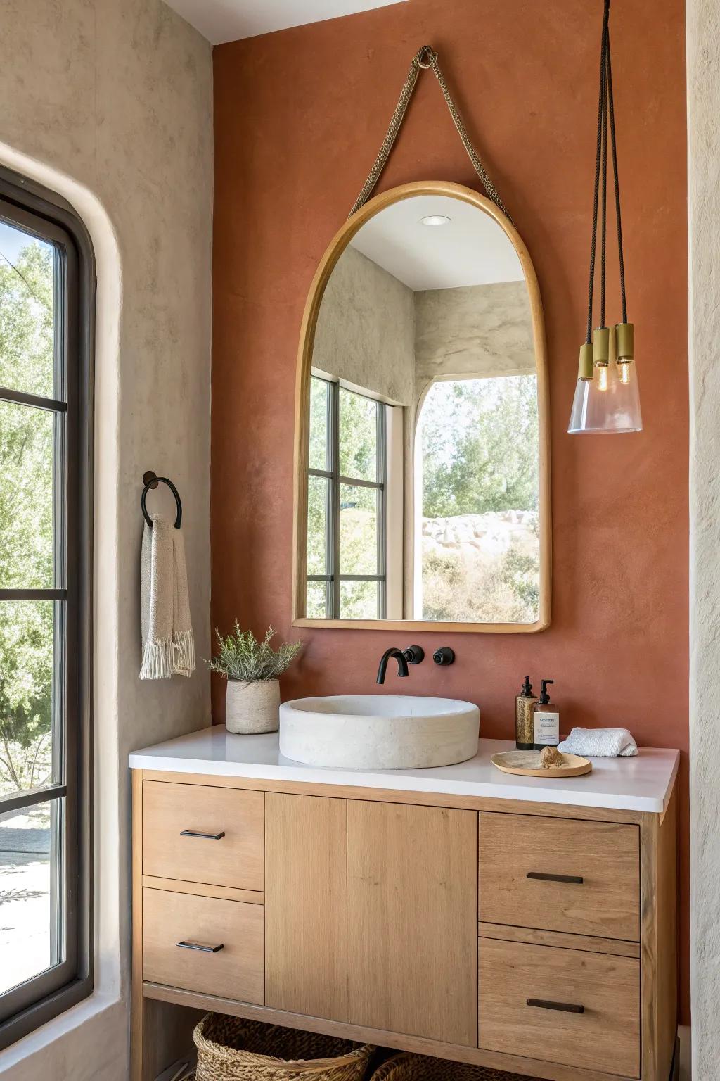 An oversized mirror brightens tiny ADU baths, doubling light and making walls feel farther away.