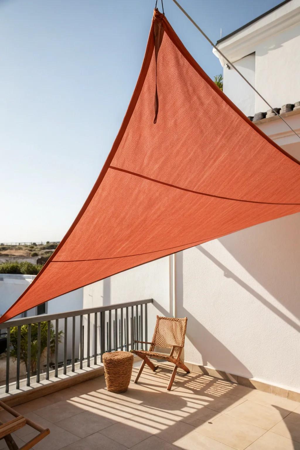 A modern shade sail adds bold color and crisp, airy sun protection for slim balconies.