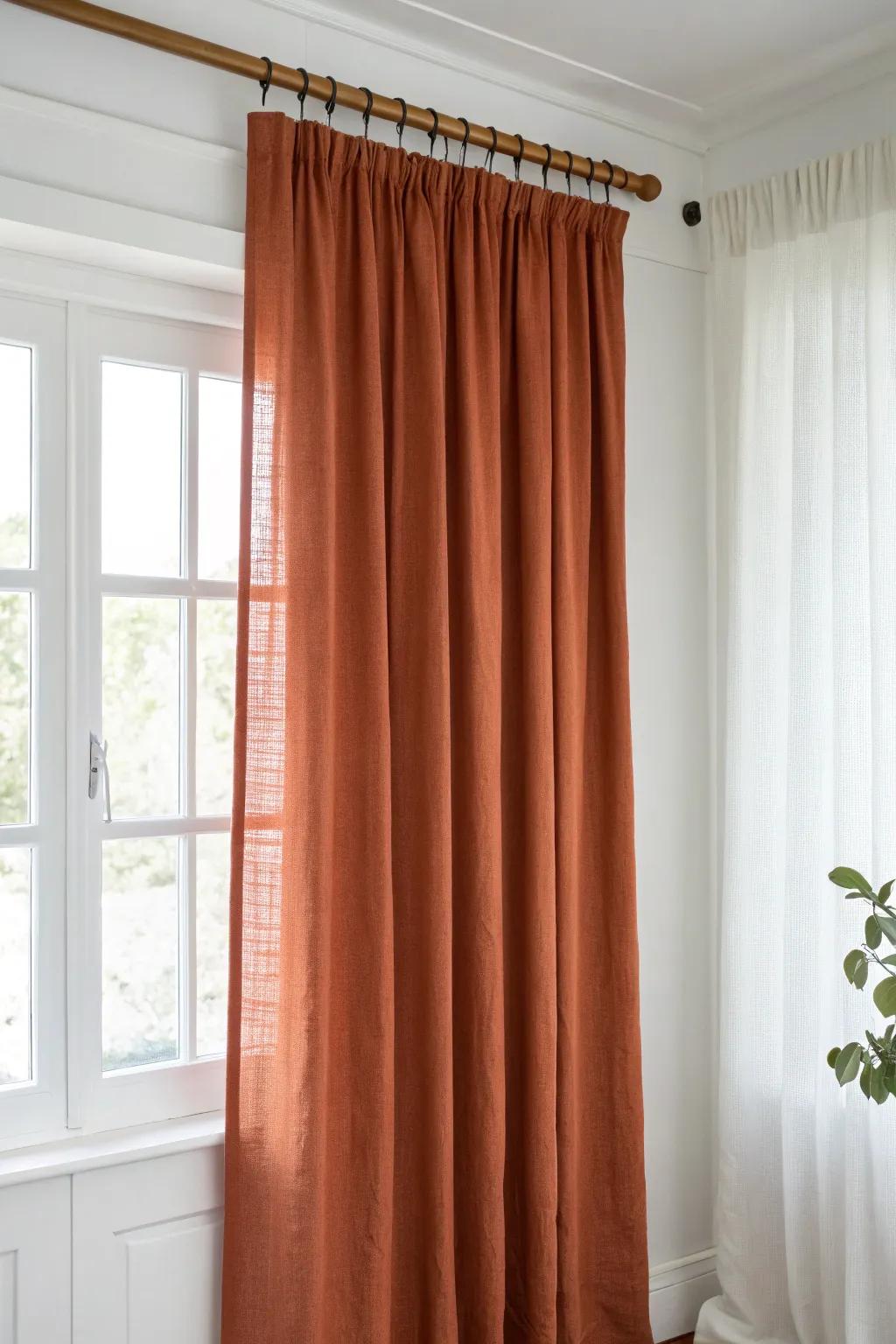 Mount curtains near the ceiling and let solid linen fall to the floor for instant height.