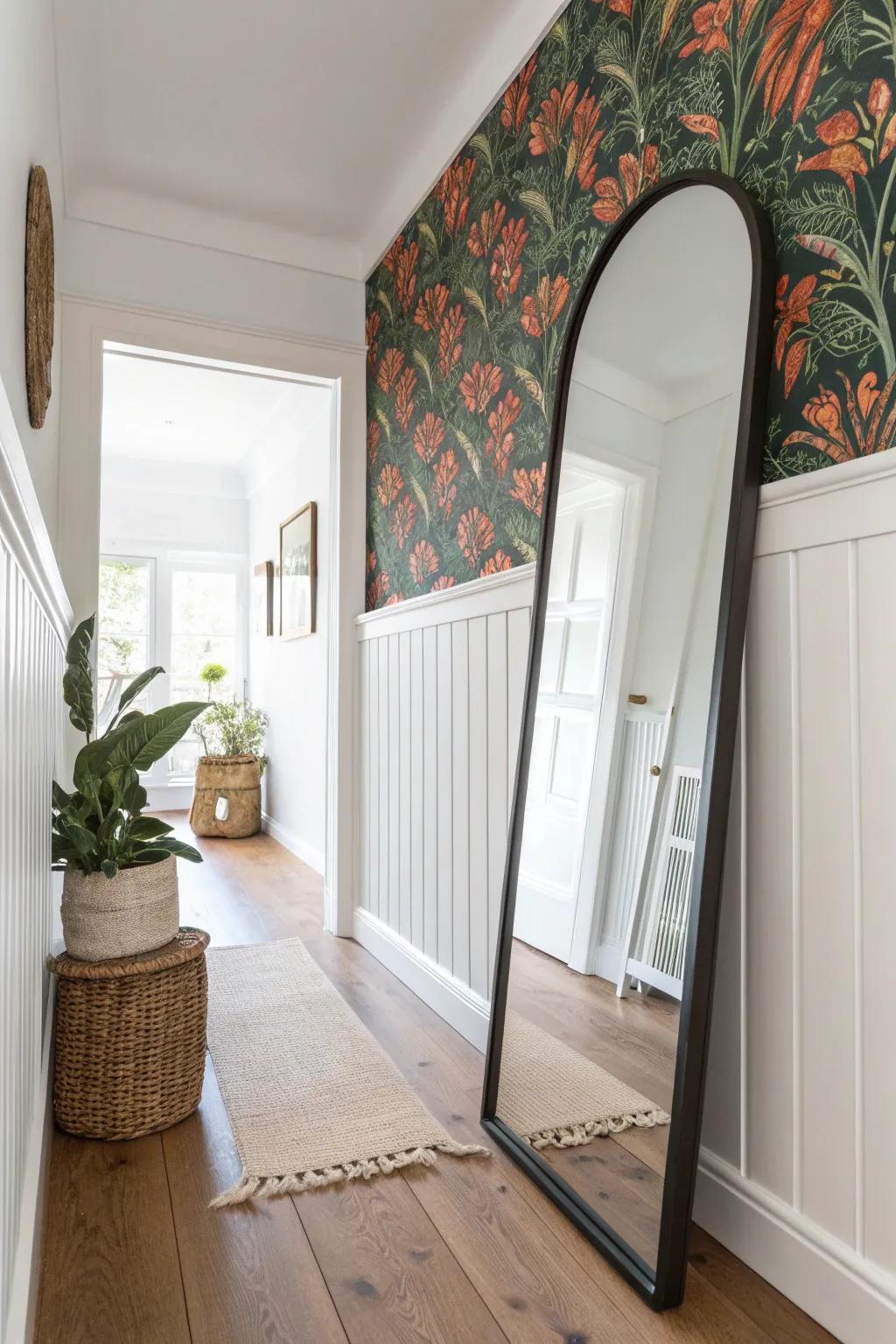 Half-wall wainscoting + bold wallpaper above makes a small hallway feel custom and protected.